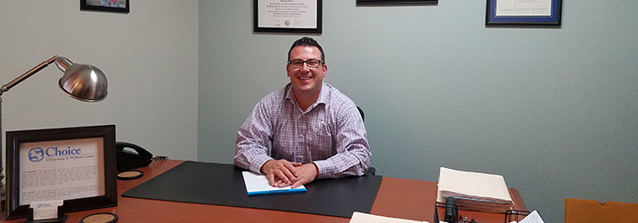 Chiropractor Boulder CO Jonathan Schnelle at Desk